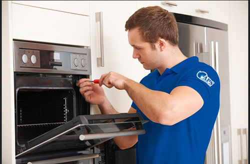 Technician repairing a built-in oven in Dubai kitchen